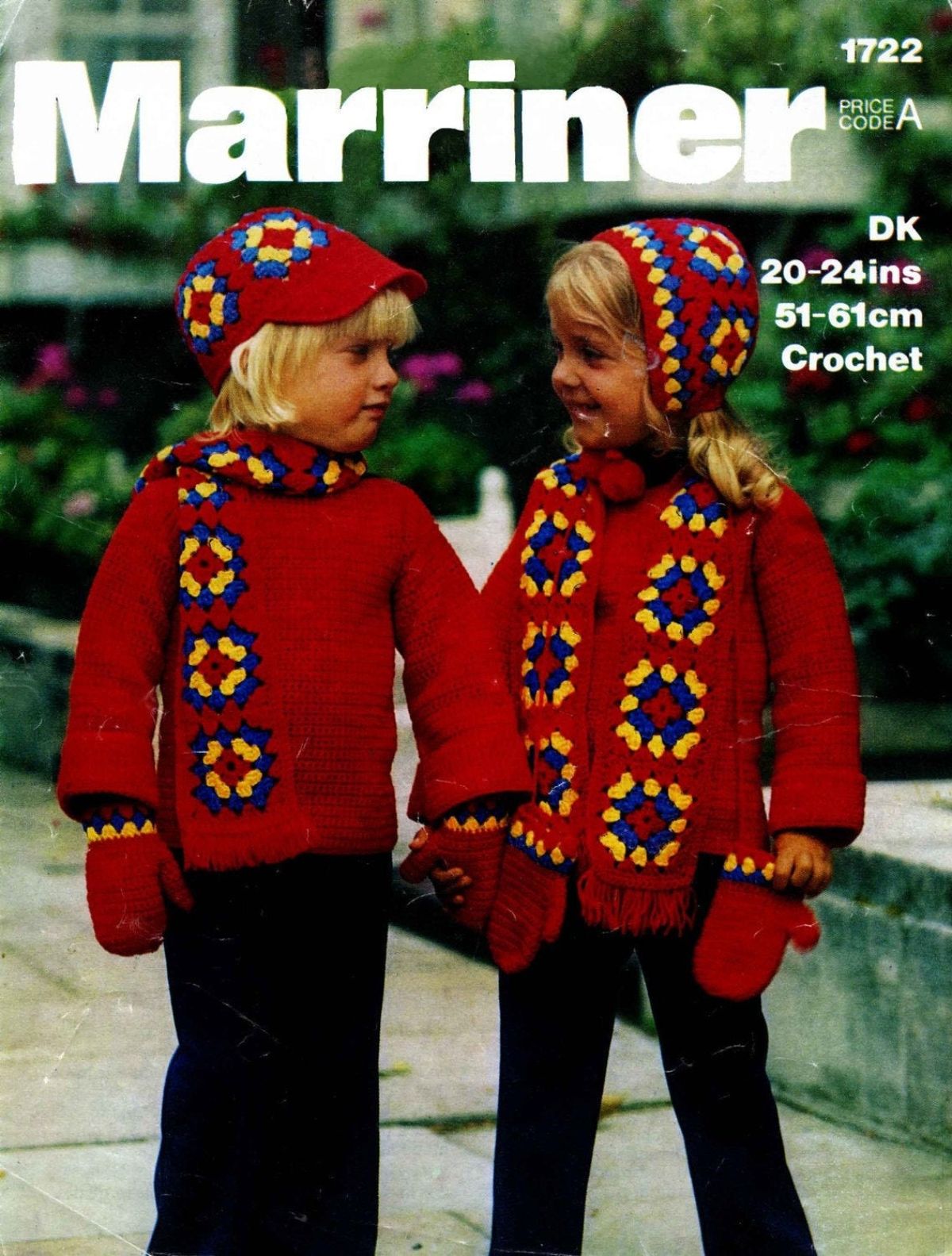 Cover of two blond children in red jumpers with vintage crochet hats and matching scarfs with yellow and blue square patterns standing outside.