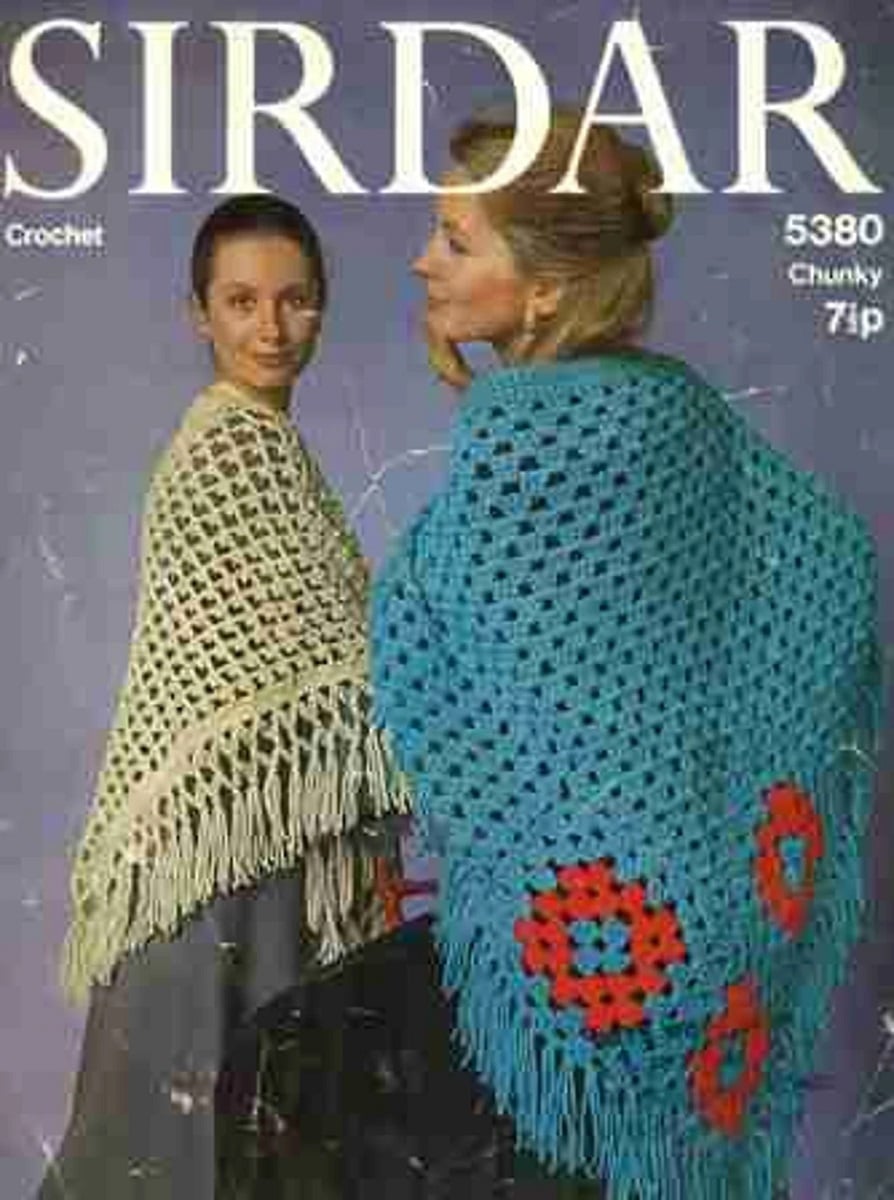 Cover of a crochet pattern with two women wearing loose weave crochet ponchos with tassels. One is cream and the other blue with red flowers stitched in.
