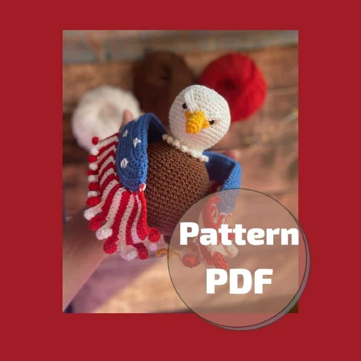  Crochet Eagle with brown body and wings with the pattern of the American flag on against a wooden background.