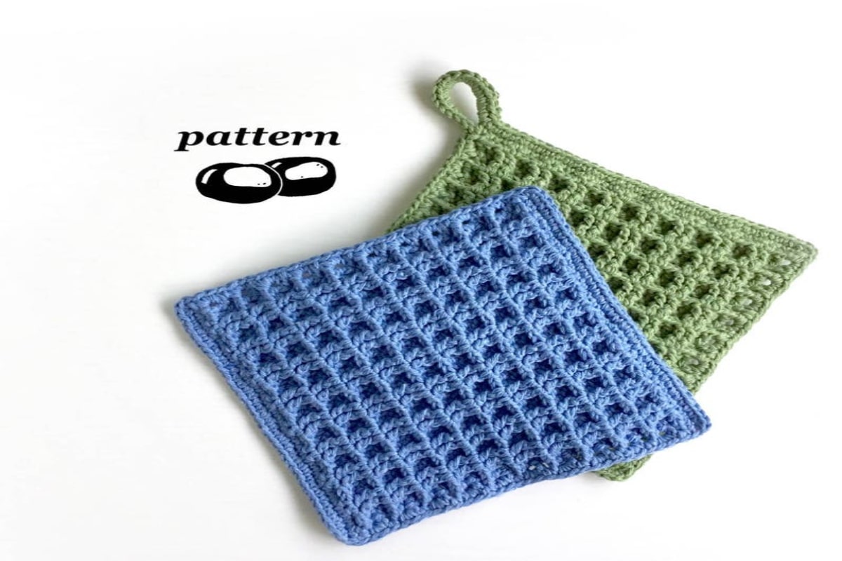 Blue crochet waffle stitch square on top of a sage green waffle stitch square on a white background.