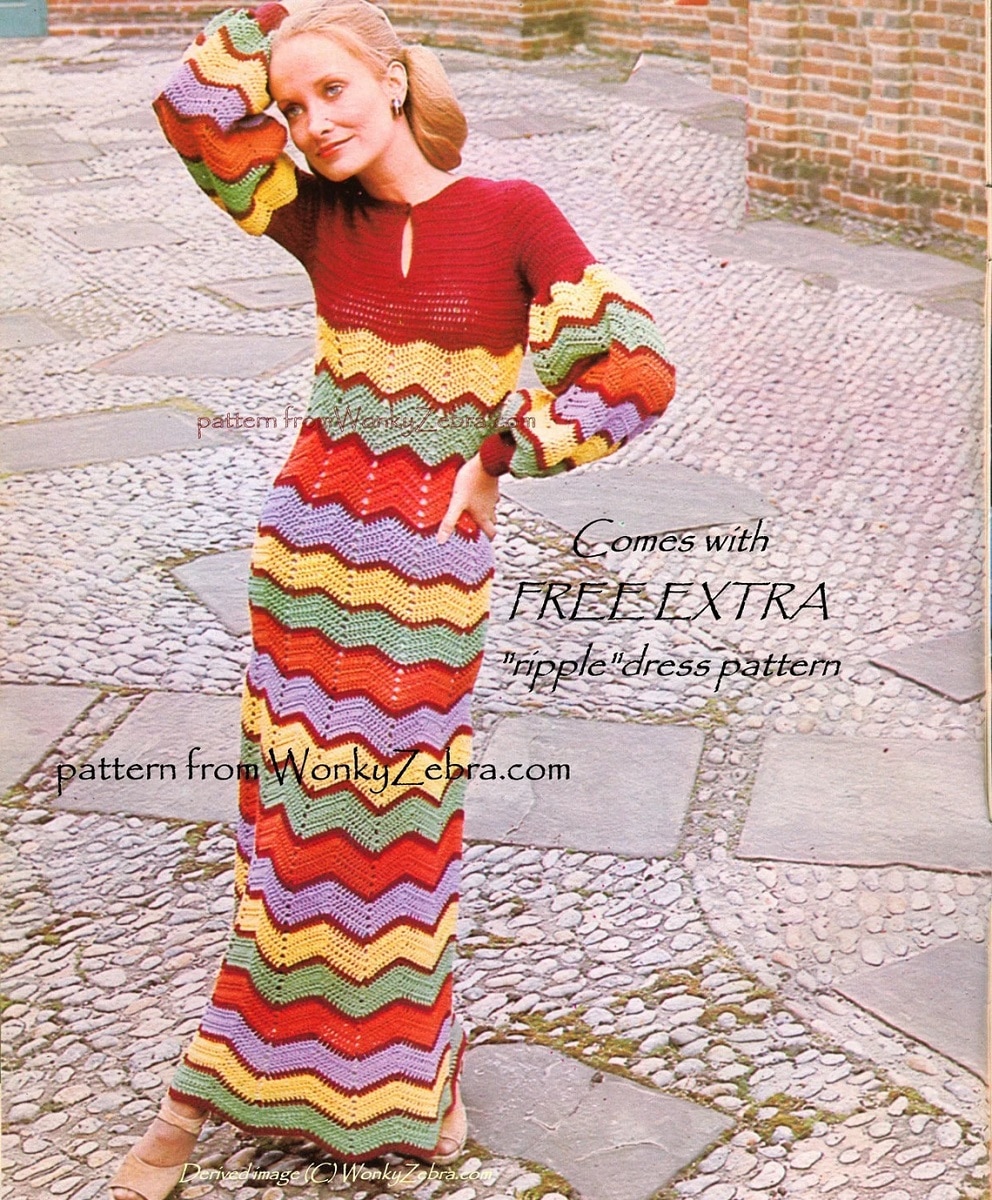 Blonde woman wearing a full length red crochet dress with yellow, green, red, and purple zig zag stripes from the chest to the floor.