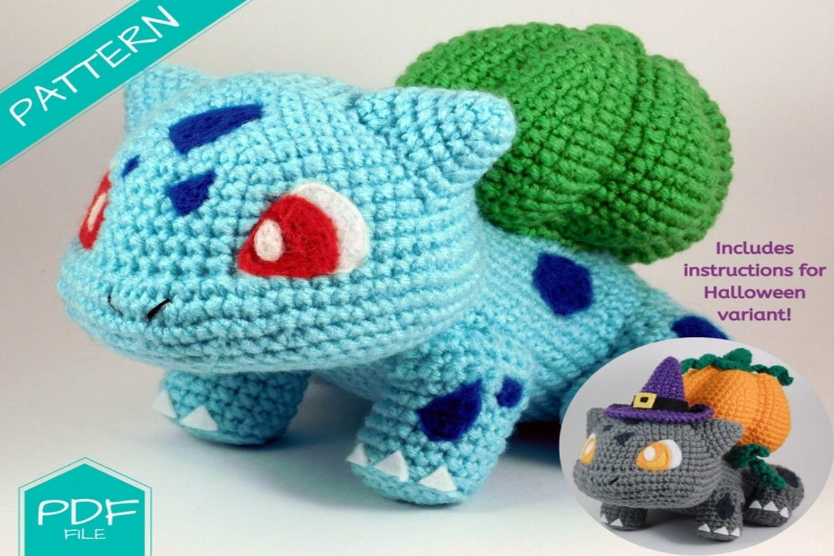 Large crochet stuffed Bulbasaur with dark blue patches over its aqua blue body and a large green pumpkin on its back standing next to a smaller version in a witches hat. 