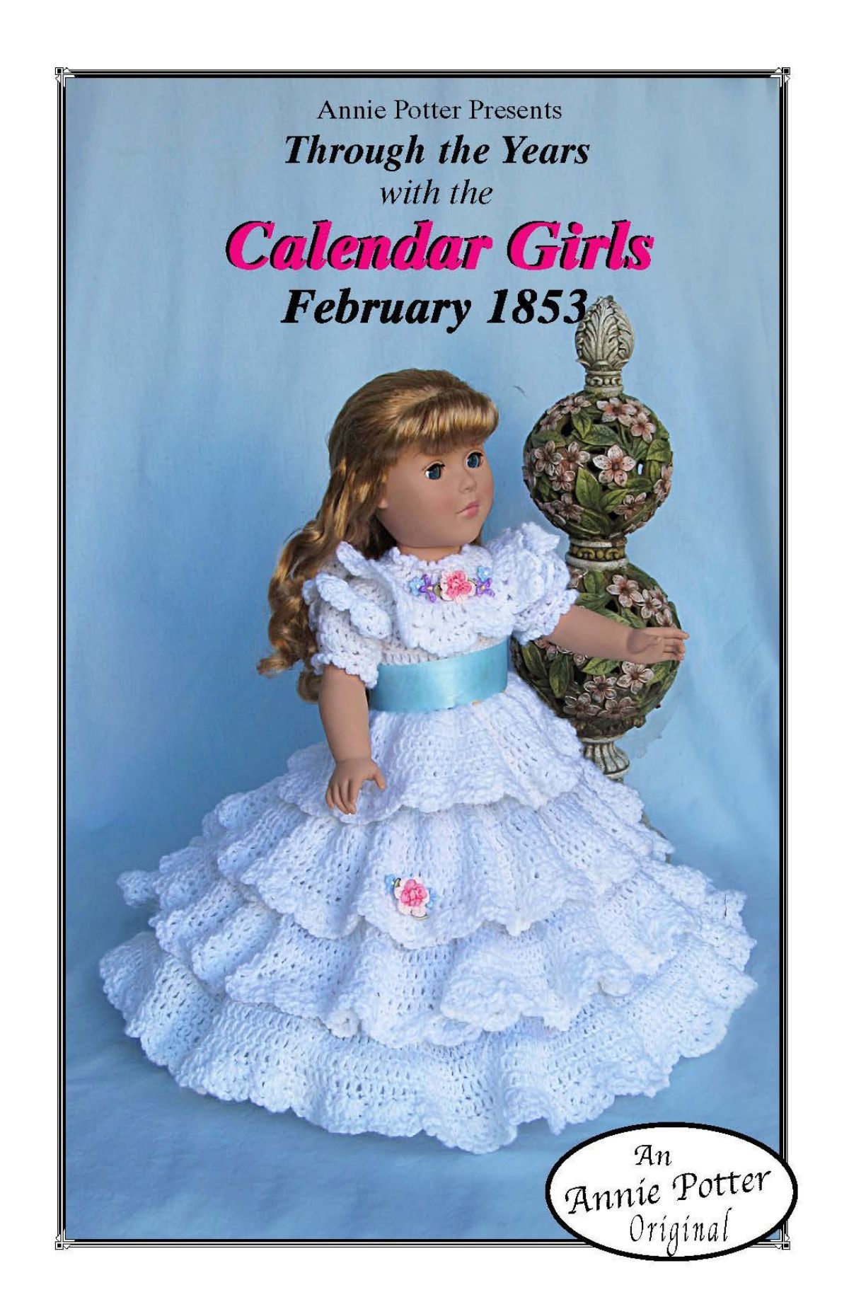 Blonde doll wearing a full length white vintage dress with ruffle sleeves and a full ruffle skirt with a thick blue ribbon around the waist.