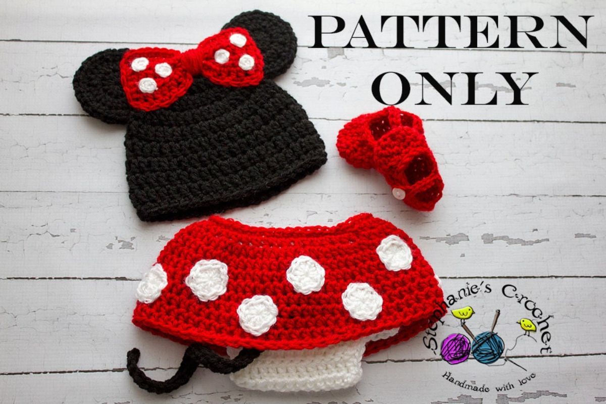  Newborn Minnie Mouse crochet costume with a black beanie with a red and white bow, a red skirt with white spots all over and small red shoes.