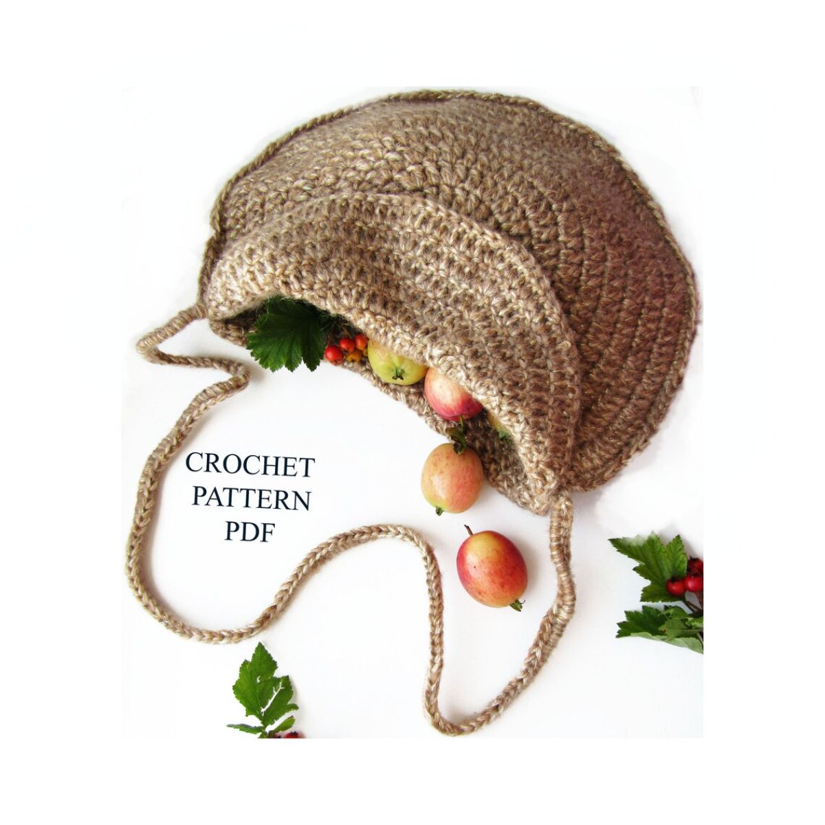 Brown crochet round bag with long handles and flap to open, filled with fruit on a white background with some leaves. 