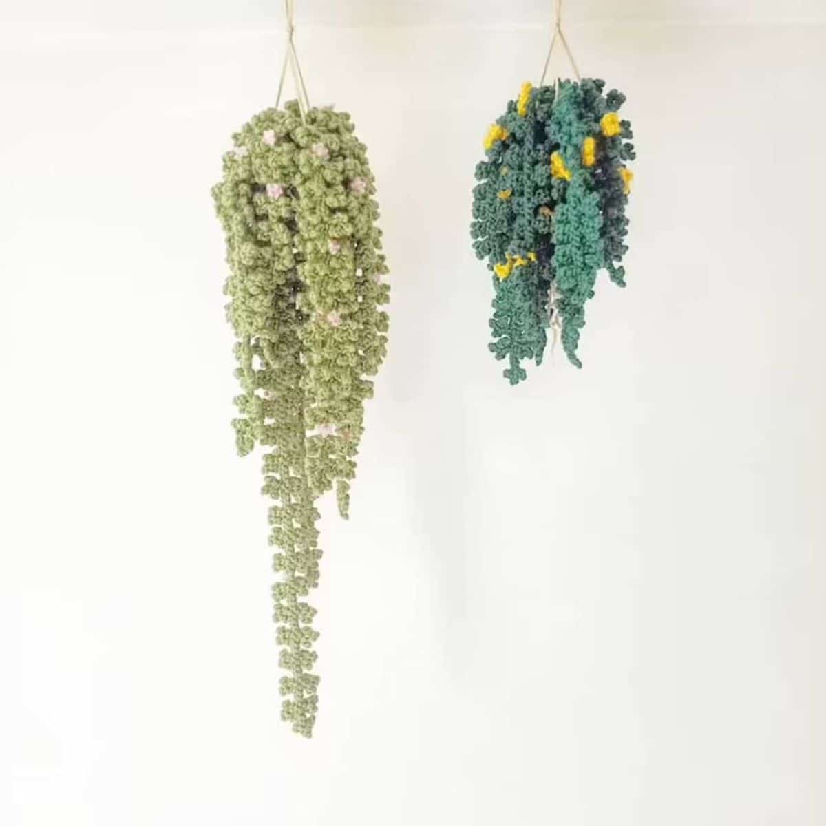 Two hanging vines of crochet foliage, one with pale green leaves and the other with dark green and yellow on a white background.
