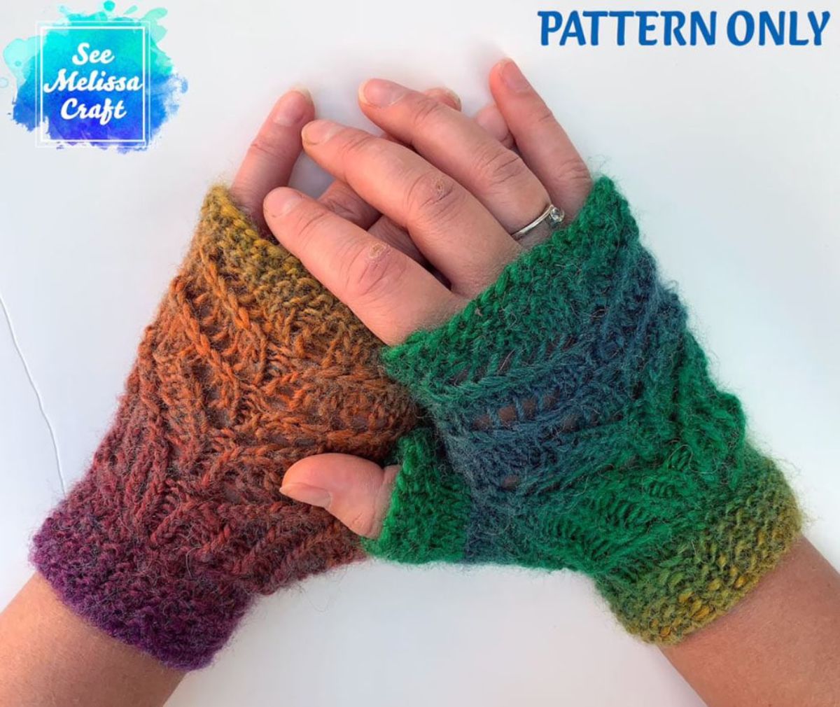 Hands on top of each other wearing lace style crochet fingerless gloves in green and brown. 