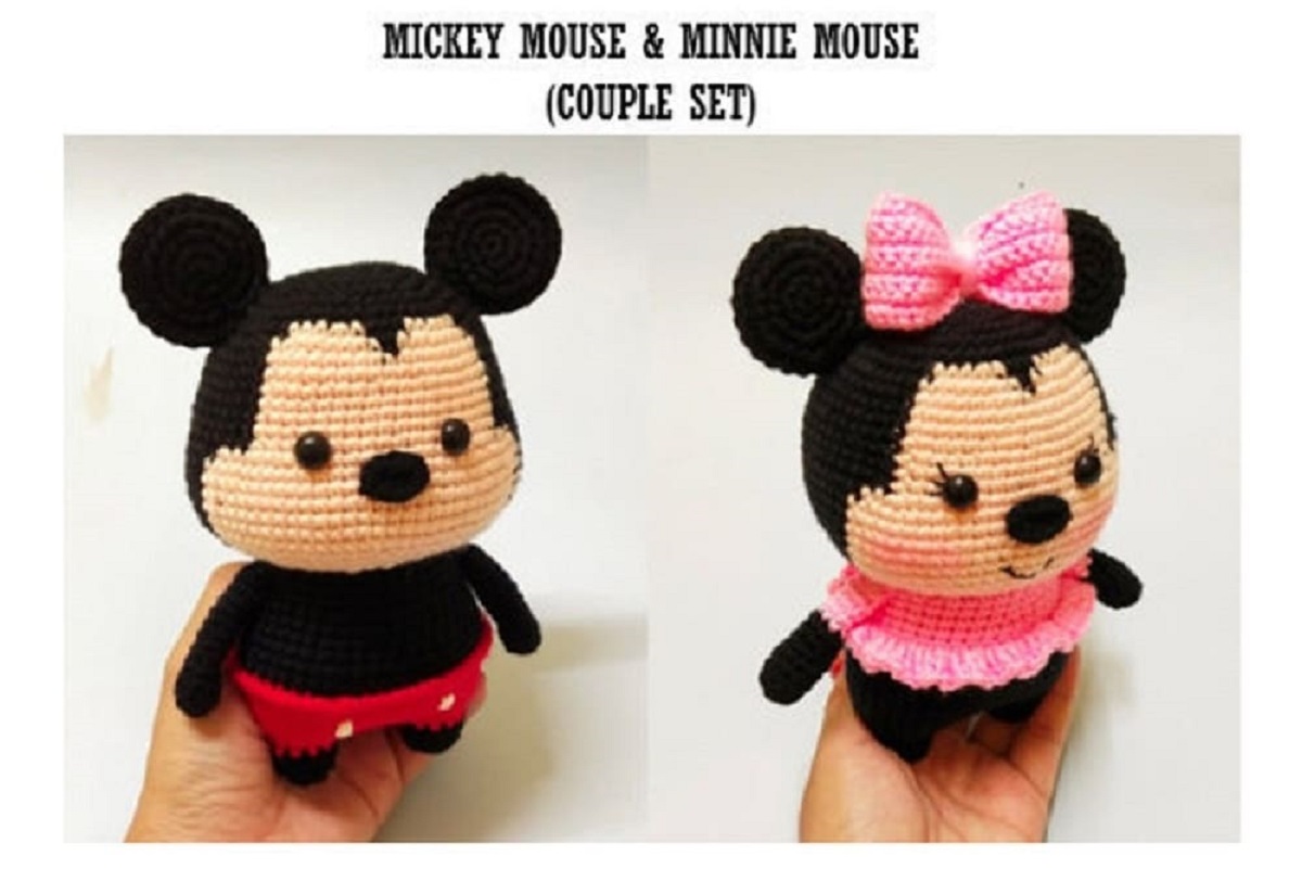 Mini crochet Mickey Mouse wearing red shorts standing next to Minnie Mouse wearing a pink bow and a pink dress.