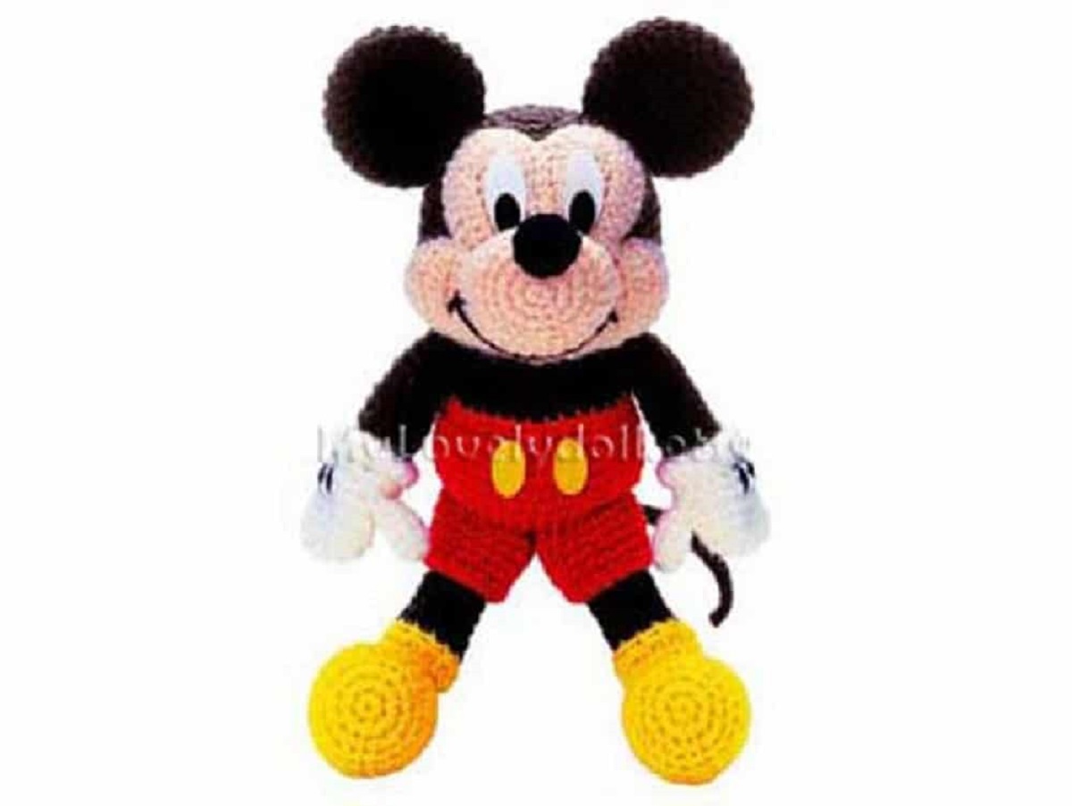 Stuffed crochet Mickey Mouse toy wearing the classic Mickey Mouse shorts and yellow shoes on a white background.