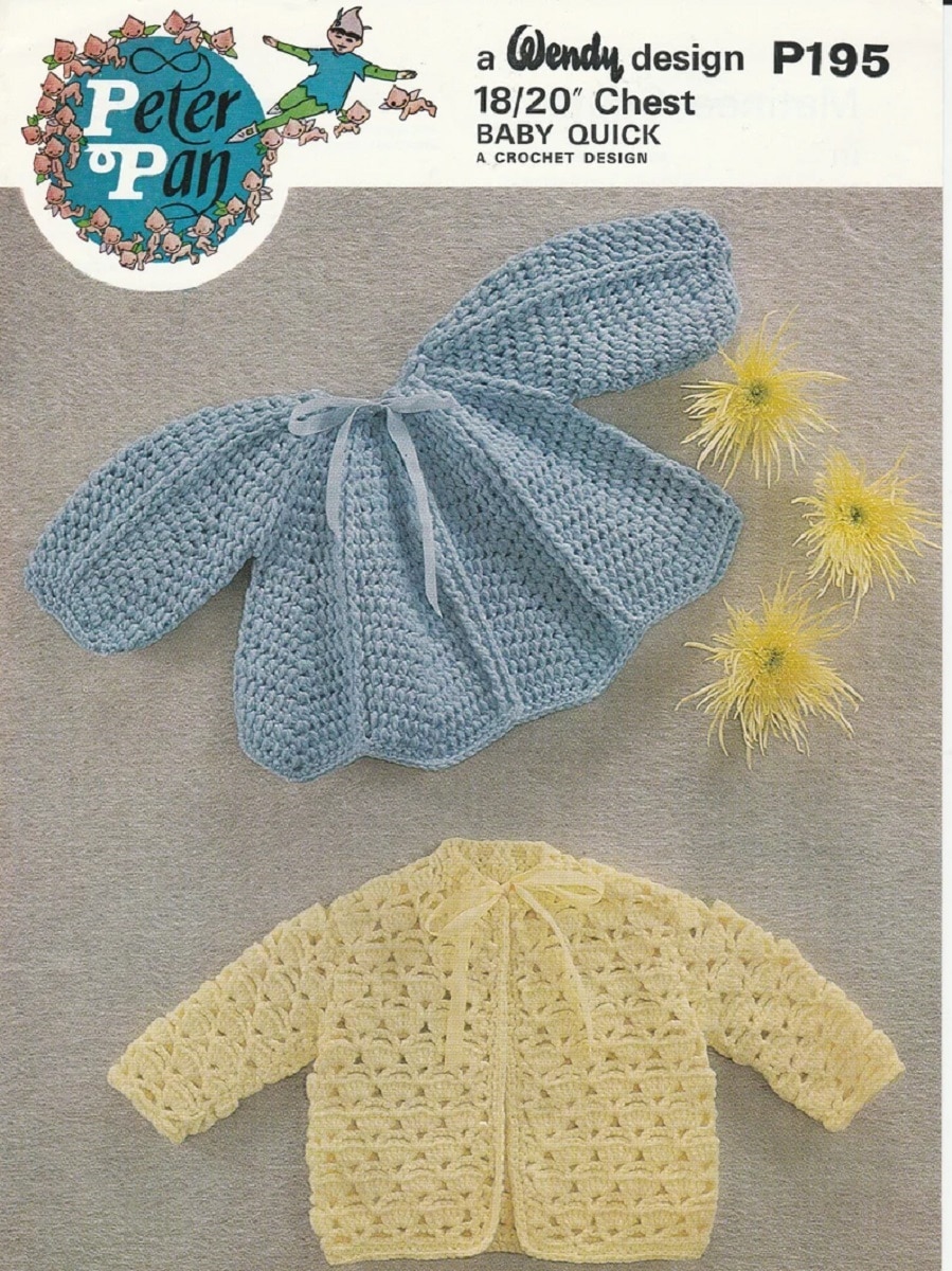 Pale blue and yellow crochet cardigans in a Peter Pan style on a gray background with yellow flowers next to them. 