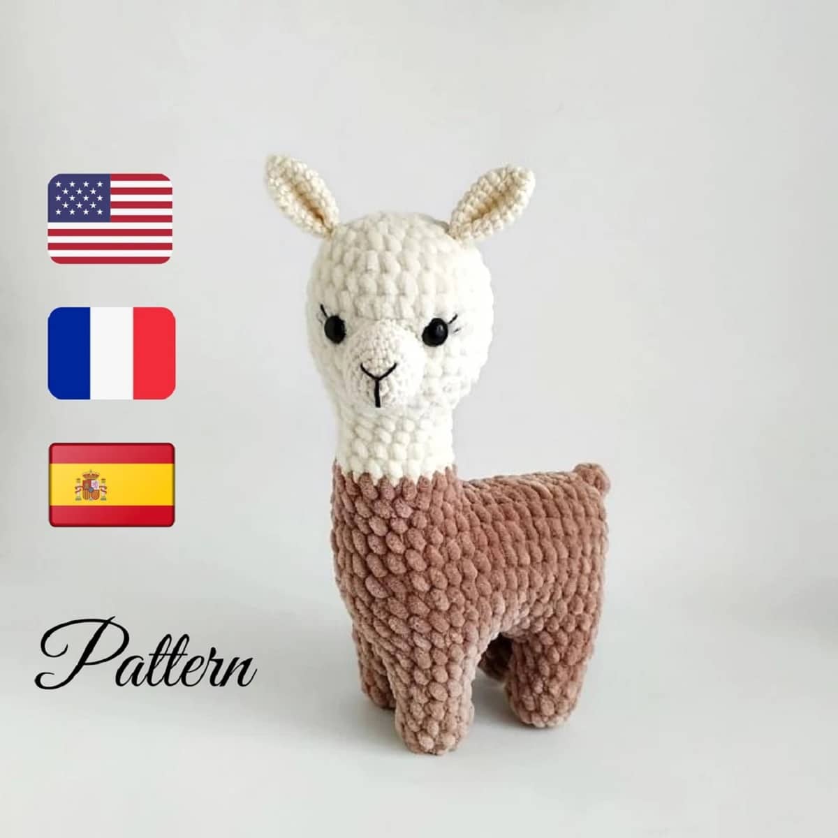  Crochet stuffed llama with brown legs and body, a white head with black eyes and nose on a white background.