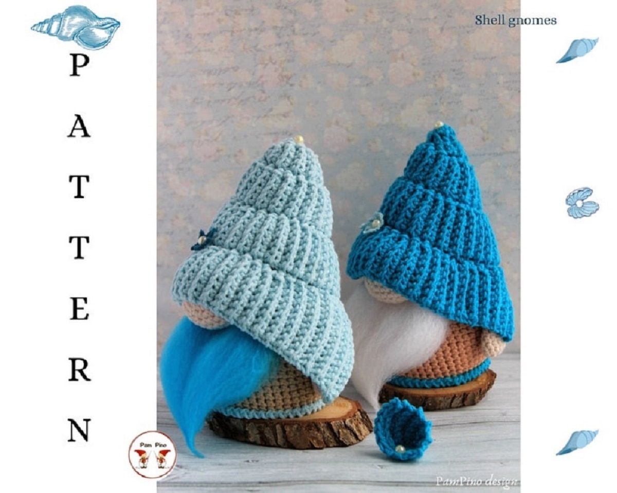 Two crochet gnomes with light blue and dark blue crochet shells over their heads and faces with blue and white beards poking out.