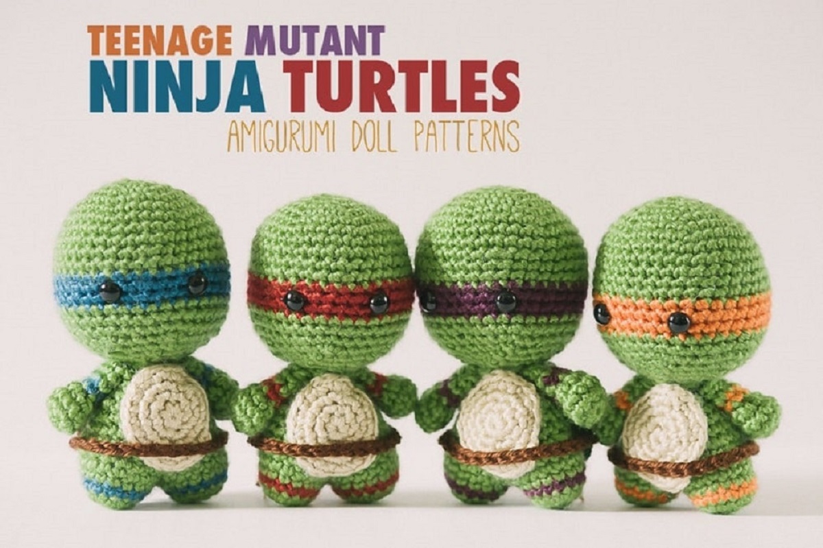 Small baby-like ninja turtles with oversized heads and orange, red, purple, and blue eye masks and brown belts on the top of their legs.