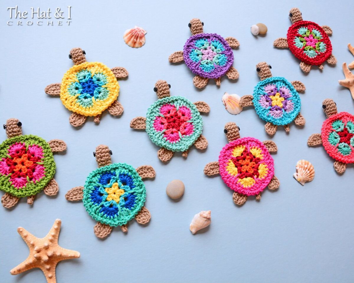 Three rows of small crochet turtle shape coasters with pink, purple, yellow, blue, green, and red shells with small flowers in the center.