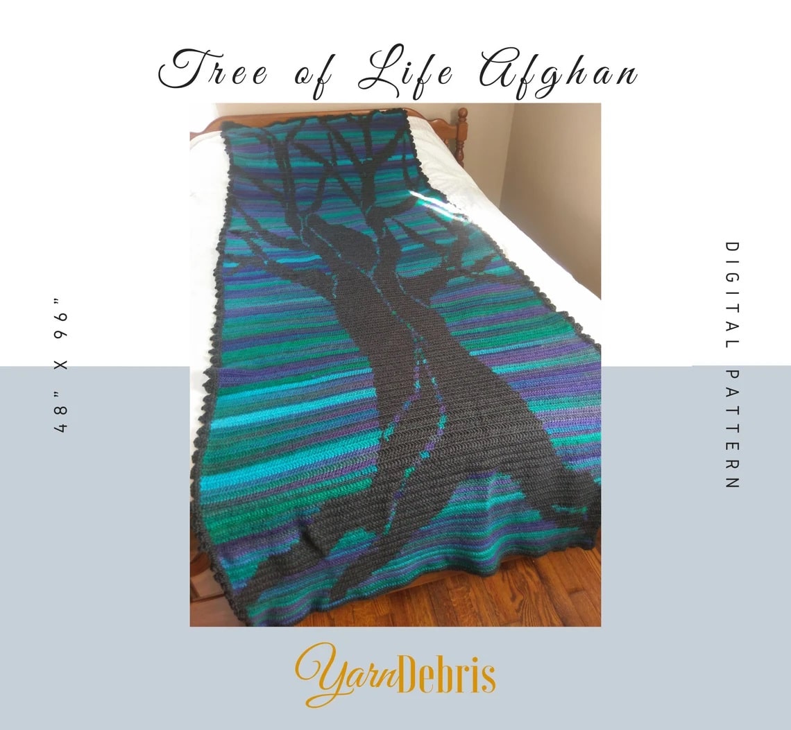 Blue, green, and purple horizontal striped blanket with a large black blanket stitched in the center with branches reaching the top of the blanket.