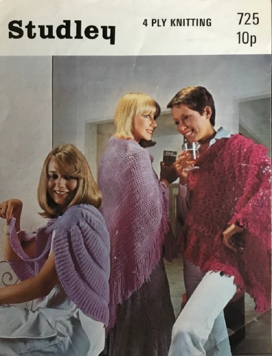 Three women wearing pink and purple crochet shawls, smiling and drinking together on the cover of a crochet pattern book.