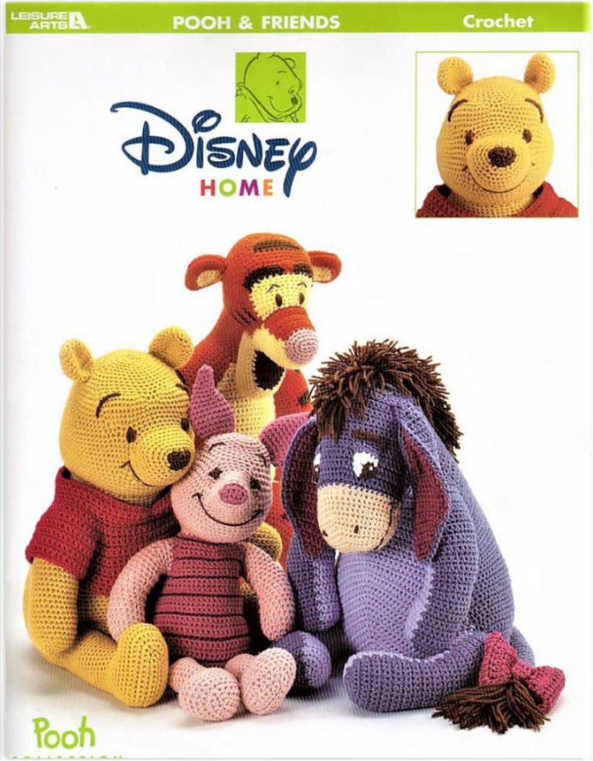 A Crochet Winnie the Pooh, Piglet, Eeyore, and Tigger sit together on a white background with the Disney logo above their heads. 