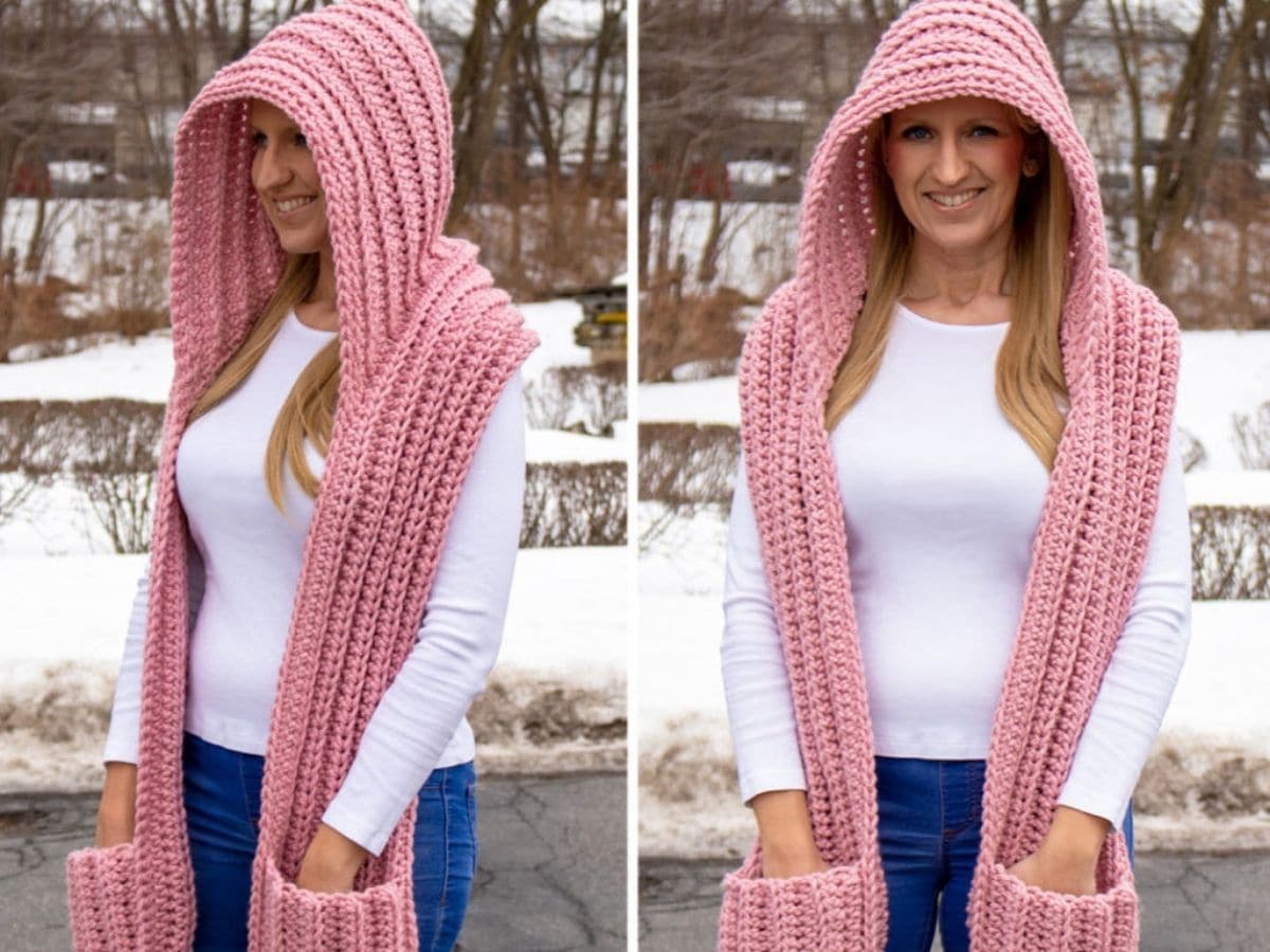 A blonde woman wearing a pink hooded scarf with pockets standing in front of some snow.
