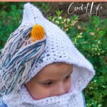 child wearing a crocheted unicorn cowl with text which reads Unicorn Hooded Cowl Free Crochet Pattern