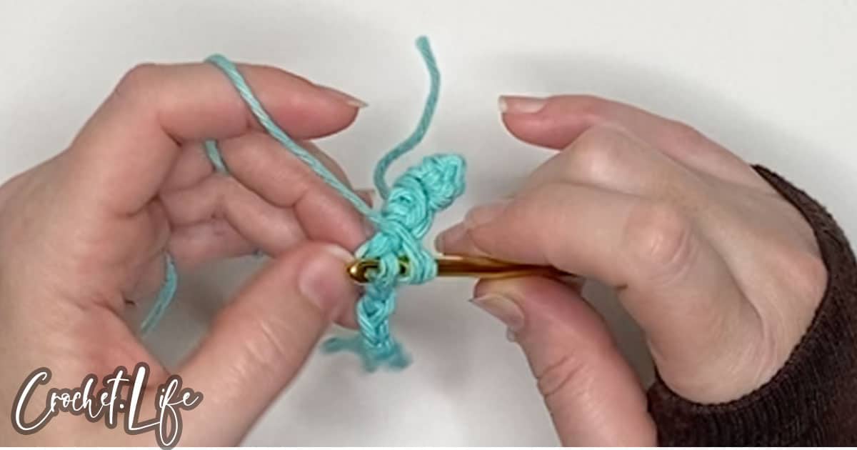 in process step of doing a half double crochet stitch to make a pot handle cozy free crochet pattern